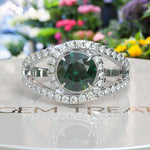 Load image into Gallery viewer, Verdant Elegance: Lustrous Round Green Emerald Surrounded by Dazzling Halo