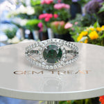 Load image into Gallery viewer, Verdant Elegance: Lustrous Round Green Emerald Surrounded by Dazzling Halo