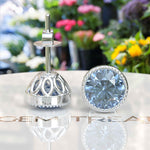 Load image into Gallery viewer, Azure Brilliance: Blue Moissanite Stud Earrings with Delicate Migraine Halo.