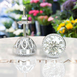 Load image into Gallery viewer, Glistening Gala: Round White Moissanite Stud Earrings with Milgrain Halo.