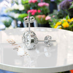 Load image into Gallery viewer, Glistening Gala: Round White Moissanite Stud Earrings with Milgrain Halo.