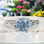 Load image into Gallery viewer, Ocean's Enchantment: 1.5ct Round Blue Moissanite Celtic Engagement Ring in Silver