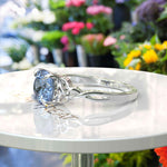 Load image into Gallery viewer, Ocean's Enchantment: 1.5ct Round Blue Moissanite Celtic Engagement Ring in Silver