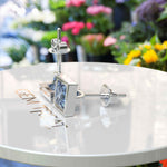 Load image into Gallery viewer, Celestial Charm: Princess-Cut Blue Moissanite Stud Earrings in Timeless Bezel Setting.