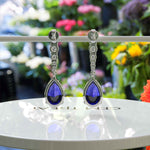 Load image into Gallery viewer, Sapphire Serenade: Pear Cut Blue Sapphire Earrings in a Graceful Drop Design.