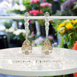 Load image into Gallery viewer, Sparkling Sips: Pear Shaped Champagne Moissanite Drop Earrings.