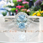 Load image into Gallery viewer, "Twisting Tides: Oval Aquamarine Ring with Moissanite Halo & Spiraled Shank