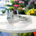 Load image into Gallery viewer, "Twisting Tides: Oval Aquamarine Ring with Moissanite Halo & Spiraled Shank