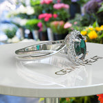 Load image into Gallery viewer, Mystic Green Gleam: Silver Halo Ring Centering Oval Emerald, Enhanced by Twisted Shank Artistry