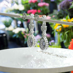 Load image into Gallery viewer, Spectral Elegance: Pear Cut Alexandrite Drop Earrings with Moissanite Halo.