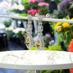 Load image into Gallery viewer, Golden Radiance: Pear Cut Citrine Drop Earrings with Sparkling Moissanite Halo.