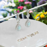 Load image into Gallery viewer, Galactic Beauty: Pear Cut Opal Earrings with Moissanite Halo, Drop Style.