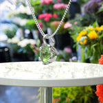 Load image into Gallery viewer, Jeweled Symphony: A Round Peridot Solitaire Pendant Necklace Awaits