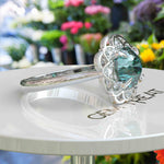 Load image into Gallery viewer, Garden of Glow: Floral Style Halo Ring with Dazzling Portuguese Cut Cyan Blue Moissanite in Silver