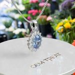 Load image into Gallery viewer, Oval Blue Moissanite Pendant Necklace Adorned with a Dazzling Halo of Moissanites