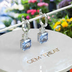 Load image into Gallery viewer, Sky’s Whisper: Blue Asscher Cut Moissanite Drop Earrings.