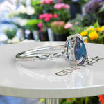 Load image into Gallery viewer, Deep Sea Elegance: Pear Cut London Blue Topaz Ring with Marquise Moissanite Accents in Silver