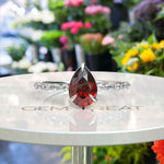 Load image into Gallery viewer, Gems of Desire and Dreams: Pear Cut Ruby Ring Elegance, Elevated by Marquise Moissanite Details