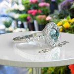 Load image into Gallery viewer, Aqua Elegance: Portuguese Cut Cyan Blue Moissanite Ring with Sparkling Halo Accent