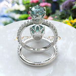 Load image into Gallery viewer, Ocean's Serenade Captured: Cyan Blue Portuguese Cut Adorns Under Halo Ring Setting