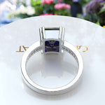 Load image into Gallery viewer, Celebrate Timeless Beauty: Adorned with 4.0ct Emerald Cut Blue Sapphire in Solitaire Setting