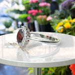 Load image into Gallery viewer, Moissanite Halo Surrounds a Brilliant Oval Red Garnet Ring