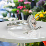 Load image into Gallery viewer, Blush Beauty: Oval Morganite Ring with Sparkling Moissanite Halo.