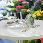 Load image into Gallery viewer, Vibrant Elegance Unleashed: Celebrate with an Oval Peridot Center in This Halo Ring