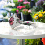Load image into Gallery viewer, Blossoming Passion: Round Ruby Ring with Floral-Styled Halo