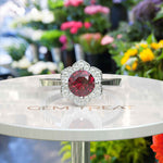 Load image into Gallery viewer, Blossoming Passion: Round Ruby Ring with Floral-Styled Halo