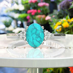 Load image into Gallery viewer, Mesmeric Blue: Oval Turquoise Ring with Brilliant Moissanite Companions.