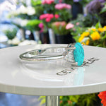 Load image into Gallery viewer, Mesmeric Blue: Oval Turquoise Ring with Brilliant Moissanite Companions.