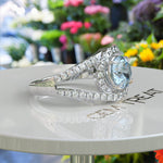 Load image into Gallery viewer, Harbor of Light: Silver Halo Ring with 1ct Round Aquamarine and Dazzling Moissanites on Split Shank
