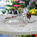 Load image into Gallery viewer, Velvety Vermilion: Round Garnet Ring Accented with Moissanite Halo
