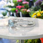 Load image into Gallery viewer, Crystal Clear Love: Lustrous Silver Ring with 1ct Oval Aquamarine and Dazzling Moissanites Split Shank Details
