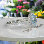 Load image into Gallery viewer, Bridal Elegance in Sea Tones: Oval Aquamarine Halo Engagement Ring&#39;s Ethereal Beauty
