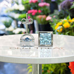 Load image into Gallery viewer, Crystal Clear Beauty: Stud Earrings Featuring Princess Cut Aquamarine in Bezel Design
