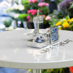 Load image into Gallery viewer, Celestial Charm: Princess-Cut Blue Moissanite Stud Earrings in Timeless Bezel Setting.
