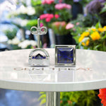 Load image into Gallery viewer, Earrings of Royalty: Bezel-Encased Princess Cut Blue Sapphire Studs.
