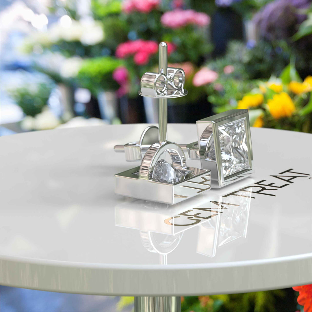 Pristine Purity: Bezel Encased Princess Cut White Moissanite Stud Earrings.