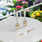 Load image into Gallery viewer, Sparkling Sips: Pear Shaped Champagne Moissanite Drop Earrings.
