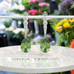 Load image into Gallery viewer, Ethereal Glow: Peridot Pear Drop Earrings with Moissanite Embellishments
