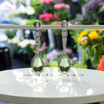 Load image into Gallery viewer, Ethereal Glow: Peridot Pear Drop Earrings with Moissanite Embellishments
