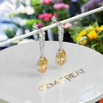 Load image into Gallery viewer, Golden Drops: Pear Cut Yellow Sapphire Drop Earrings with Moissanite Sparkle.
