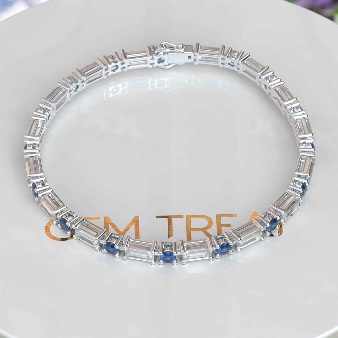 Azure Mystery, Round London Blue Topaz Tennis Bracelet with Baguette Moissanite Interlude