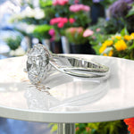 Load image into Gallery viewer, Spiraled Elegance: Halo Ring Featuring 1ct Oval White Moissanite on a Twisted Silver Band
