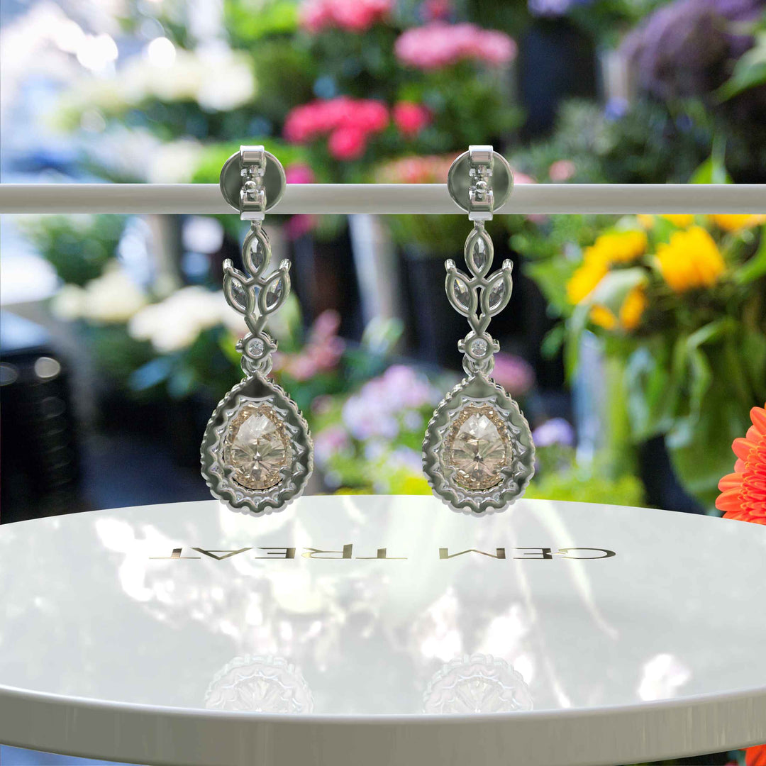 Golden Whispers: Pear Cut Champagne Moissanite Halo Drop Earrings Accented with Marquise Moissanites.