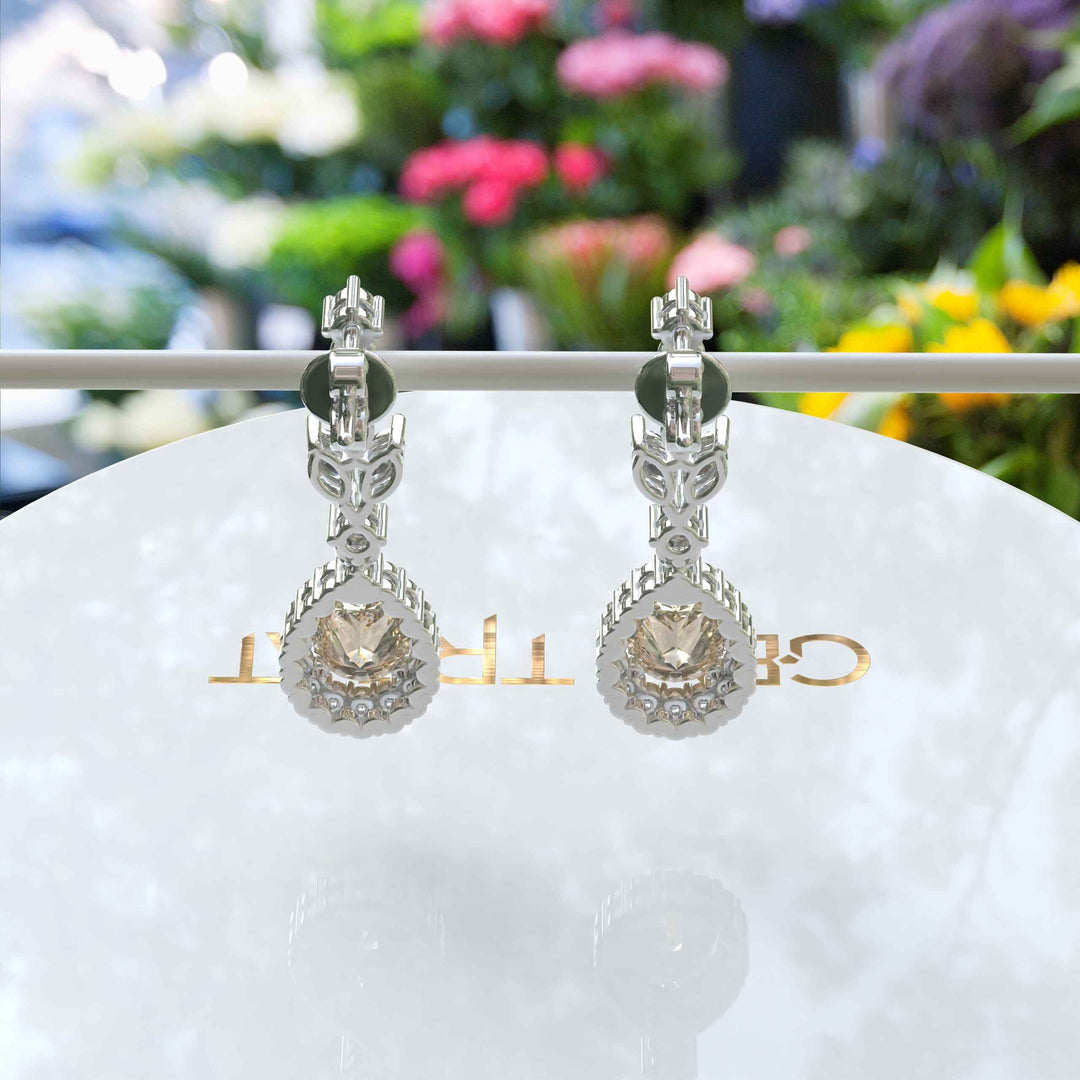 Golden Whispers: Pear Cut Champagne Moissanite Halo Drop Earrings Accented with Marquise Moissanites.