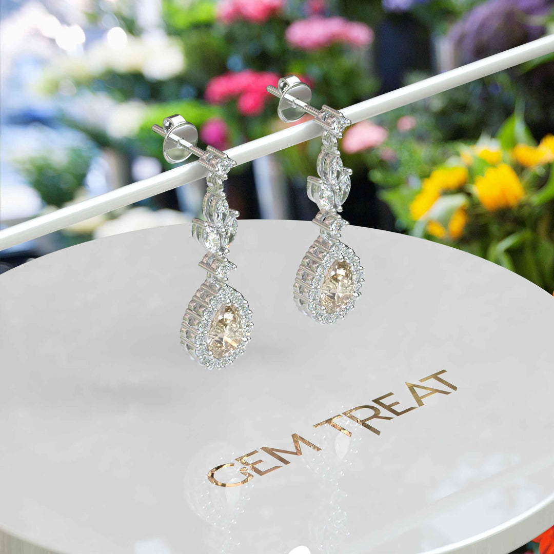 Golden Whispers: Pear Cut Champagne Moissanite Halo Drop Earrings Accented with Marquise Moissanites.