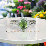 Load image into Gallery viewer, Green Oasis &amp; Spiraled Elegance: Halo Ring Spotlighting Oval Peridot with Twisted Shank
